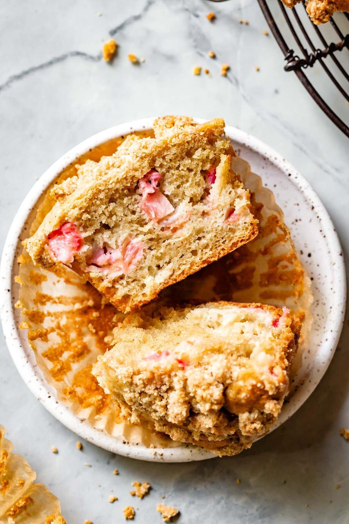 a halved muffin loaded with jammy, pink rhubarb